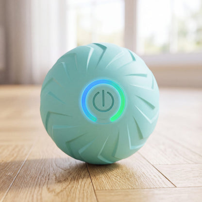 Balle pour chien rebondissante intelligente turquoise avec bouton lumineux, gros plan sur parquet