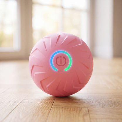 Balle pour chien rebondissante intelligente rose avec bouton lumineux, gros plan sur parquet