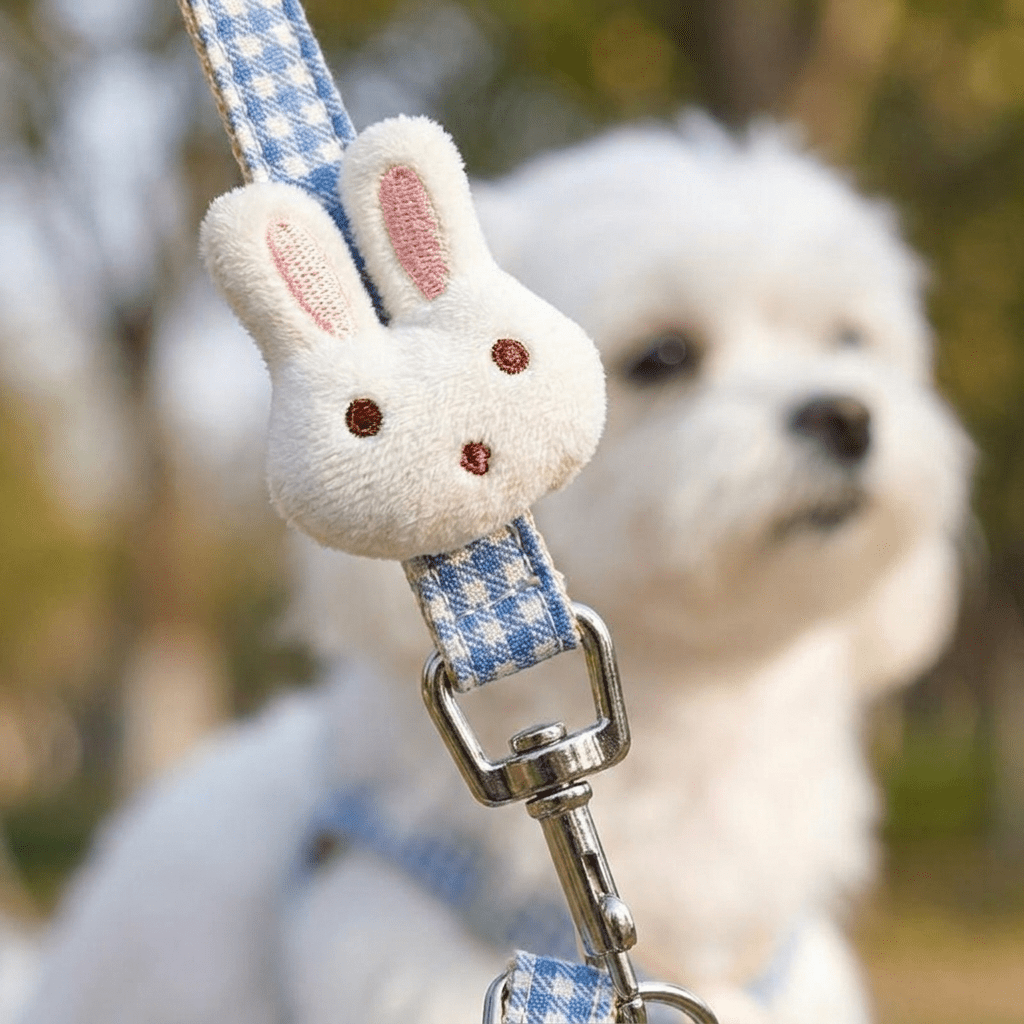 Gros plan macro sur le pompon lapin en peluche du harnais petit chien LapinChou bleu à carreaux vichy