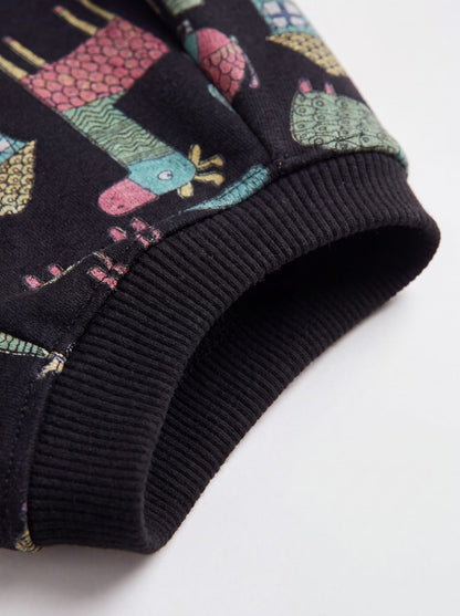 Zoom sur le poignet côtelé noir du pull chien doublé polaire à motif d'animaux