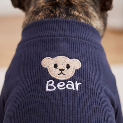 Gros plan sur l'ourson brodé et le mot Bear du pull chien bleu marine