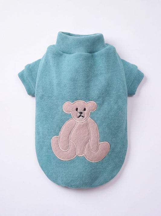 Pull chien turquoise vu de dos avec un grand ourson beige appliqué, maille lisse et col montant