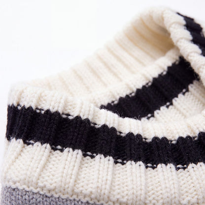 Gros plan sur le col côtelé rayé noir et blanc du pull chien tricot gris