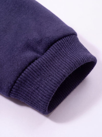 Gros plan sur le poignet côtelé du sweat à capuche chien bleu marine